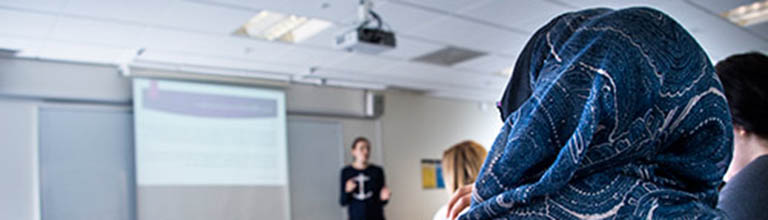 Person sat in a workshop presentation listening to speaker